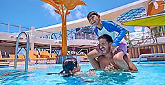Son on dad's shoulder having fun with sister